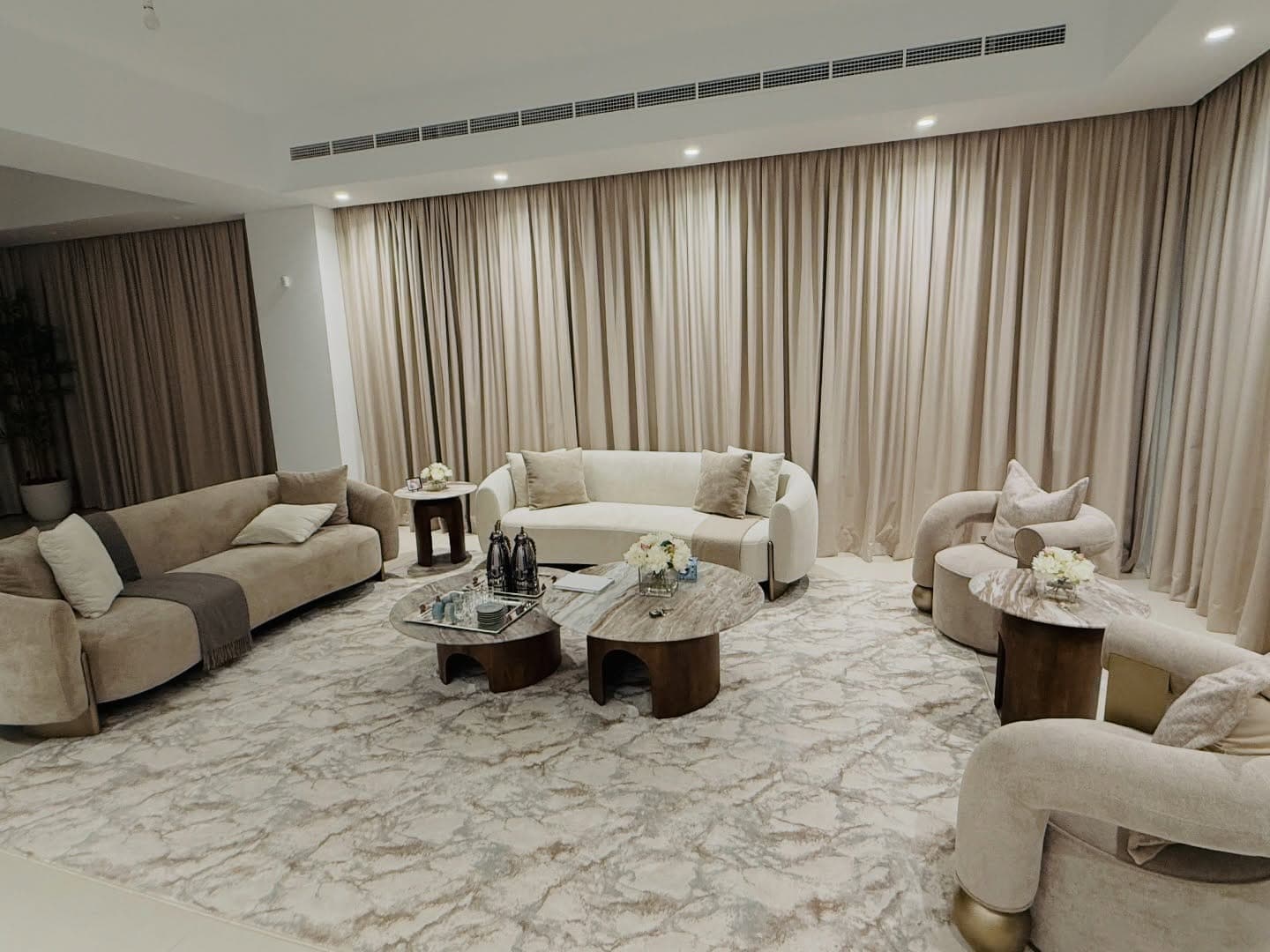 Full-height custom curtains in a finished villa living room